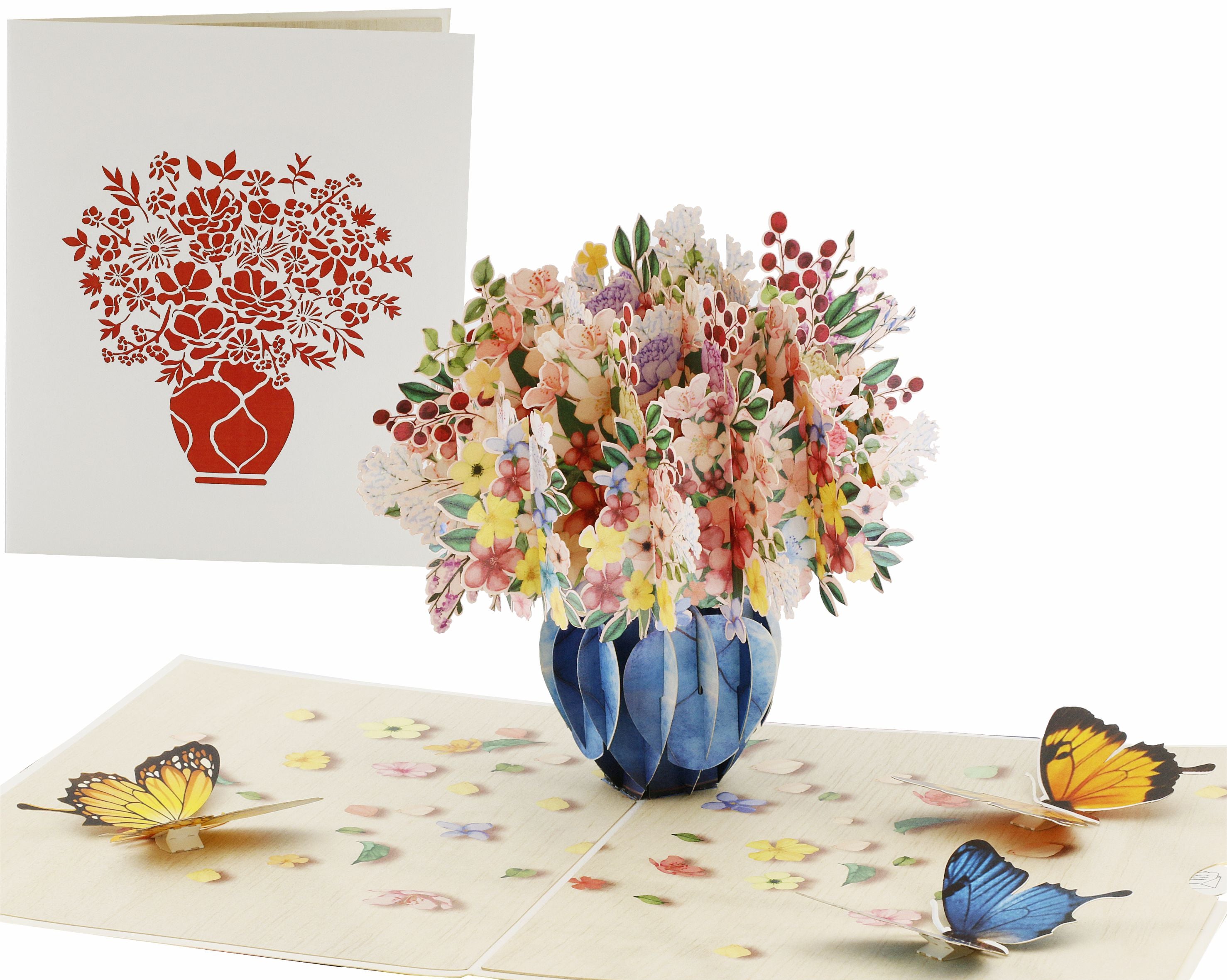 Aufgeklappte Pop-up-Karte mit einem bunten Blumenstrauß in blauer Vase und Schmetterlingen, daneben die weiße Kartenvorderseite mit Blumenstrauß-Scherenschnitt.