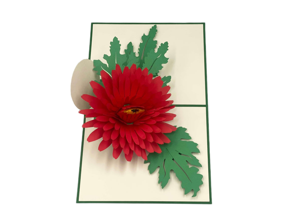 Aufgeklappte Pop-up-Karte mit roter Chrysantheme, schräg von oben fotografiert.