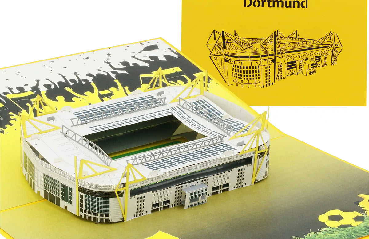 Aufgeklappte Pop-up-Karte mit einem detailreichen Modell eines Fußballstadions und einer gelben Karte mit einem schwarzem Scherenschnitt des Stadions und dem Schriftzug Dortmund.