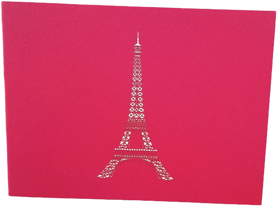 Pinke Kartenvorderseite mit dem Eiffelturm als Scherenschnitt.