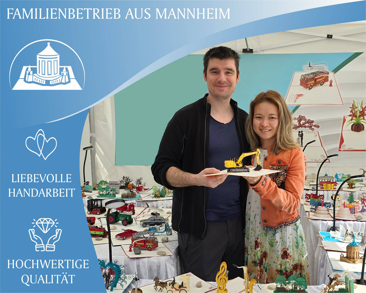 Tram und Christian, Gründer von design3dkarten stehen zusammen in einem zelt und halten eine pop up karte mit einem bagger in der hand.