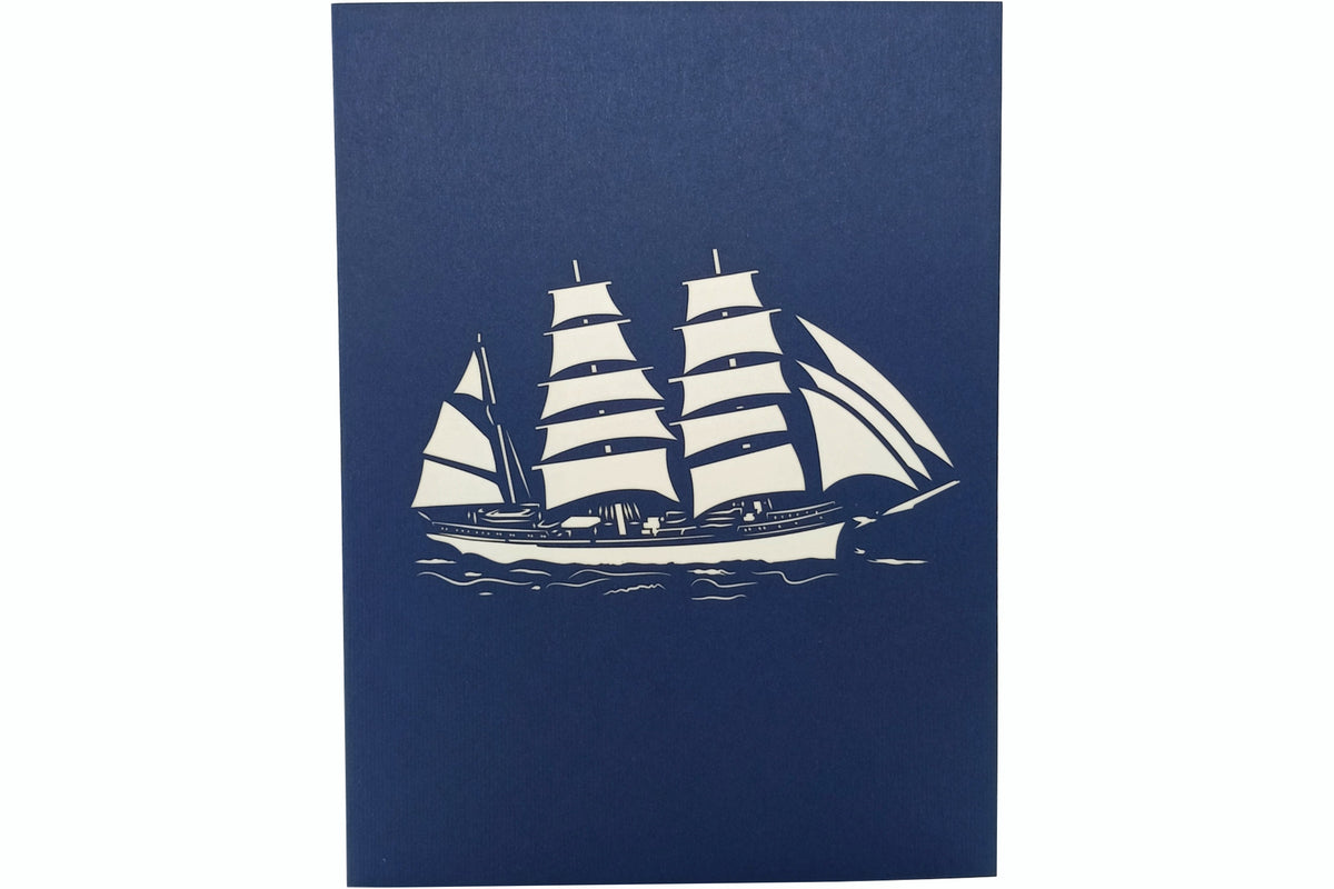 Blaue Karte mit Gorch Fock Schiff mit drei Segelmasten als ausgeschnittenes Motiv im Scherenschnitt Stil.