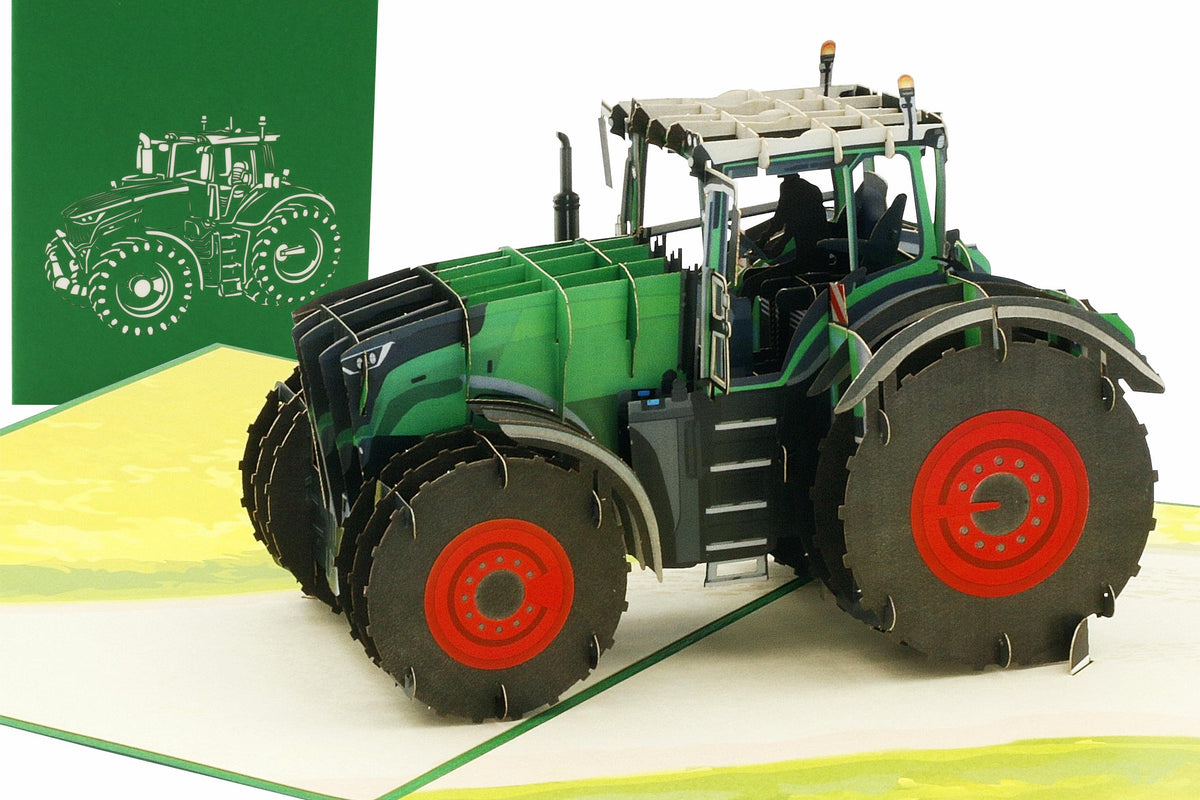Aufgeklappte Pop-up-Karte mit einem grünen Traktor mit roten Felgen auf einem Feld, dahinter die grüne Kartenvorderseite mit Traktor-Scherenschnitt.
