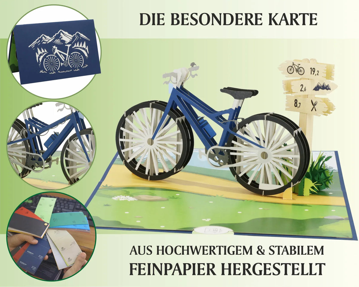 Aufgeklappte Pop-up-Karte mit detailreichem Fahrradmodell aus Papier, daneben Wegweiser und Wiese, oben links geschlossene Karte mit Fahrradsilhouette.