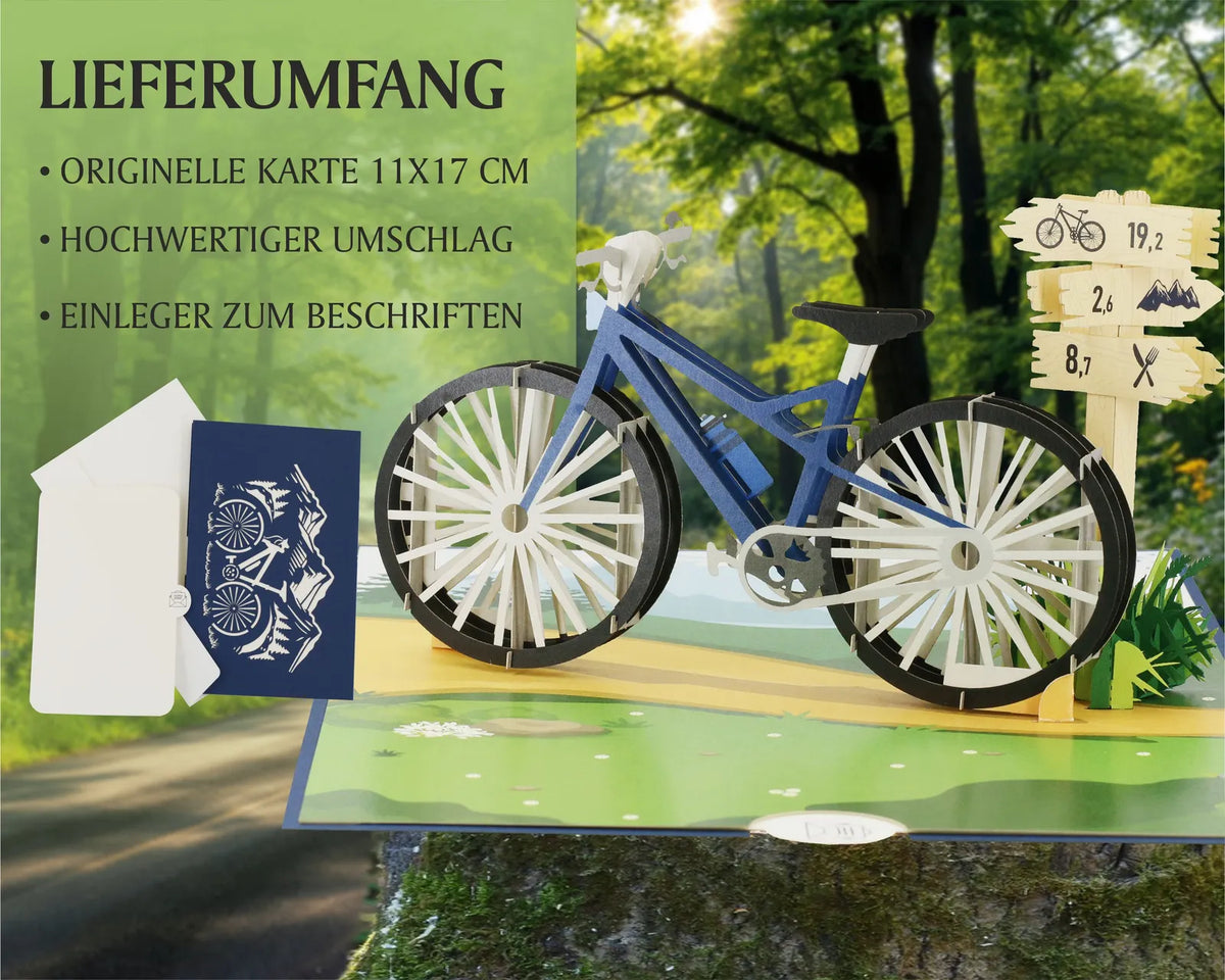 pop up karte aus papier mit einem blauen mountainbike und wegweiser. im hintergrund ist ein radweg im wald abgebildet.