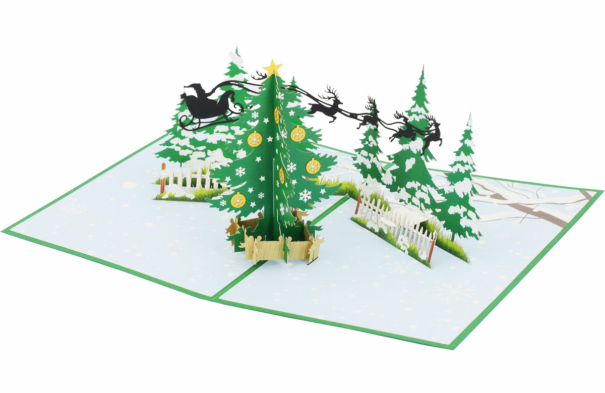 Aufgeklappte Pop-up-Karte mit Tannenbaum, Zaun und fliegendem Rentierschlitten, seitlich fotografiert.