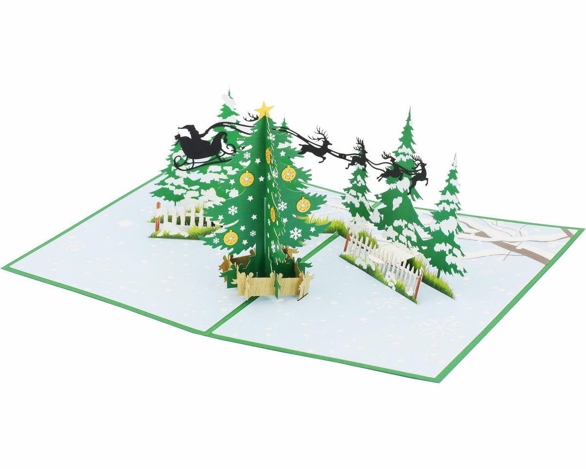 Aufgeklappte Pop-up-Karte mit Tannenbaum, Zaun und fliegendem Rentierschlitten, seitlich fotografiert.