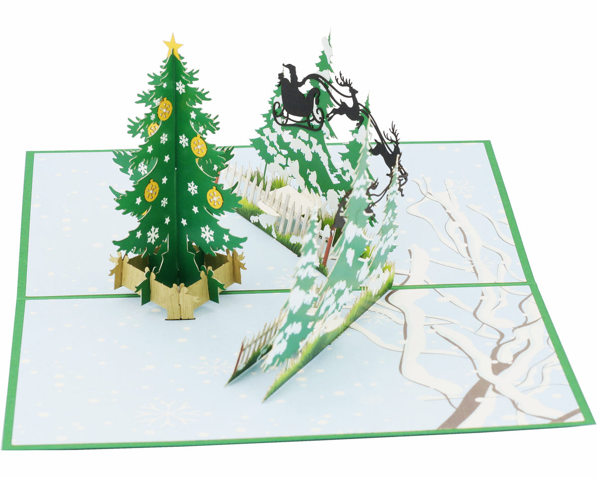 Nahaufnahme der aufgeklappten Pop-up-Karte mit geschmücktem Tannenbaum und Rentierschlitten.