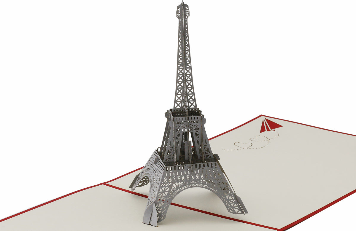 Aufgeklappte Pop-up-Karte mit einem detailreichen Eiffelturm aus Papier, schräg von der Seite fotografiert.