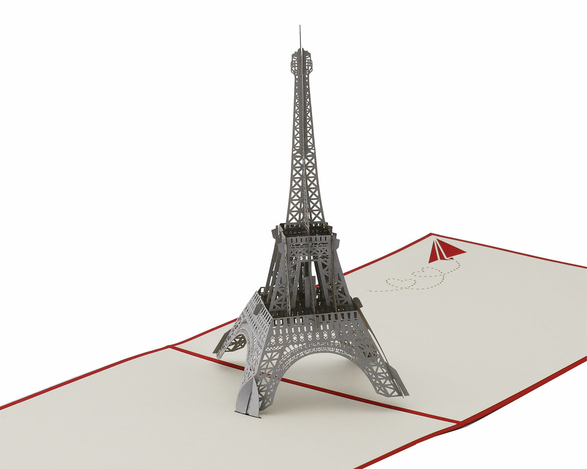 Aufgeklappte Pop-up-Karte mit einem detailreichen Eiffelturm aus Papier, schräg von der Seite fotografiert.