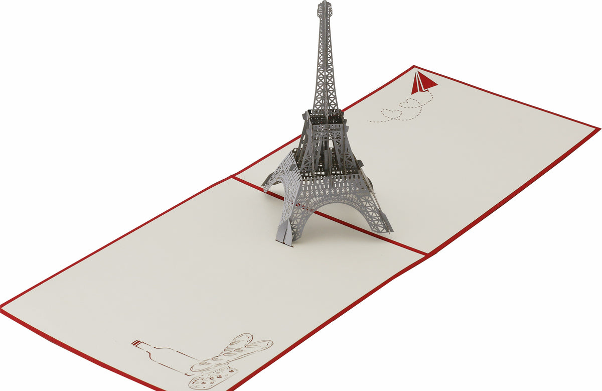 Aufgeklappte Pop-up-Karte mit Eiffelturm aus Papier, von schräg oben fotografiert.