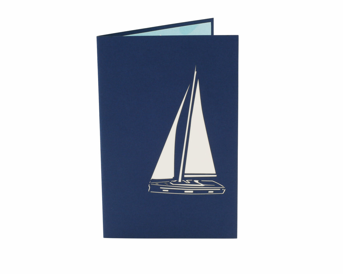 Klappkarte in blau mit einem Segelboot als Scherenschnitt.