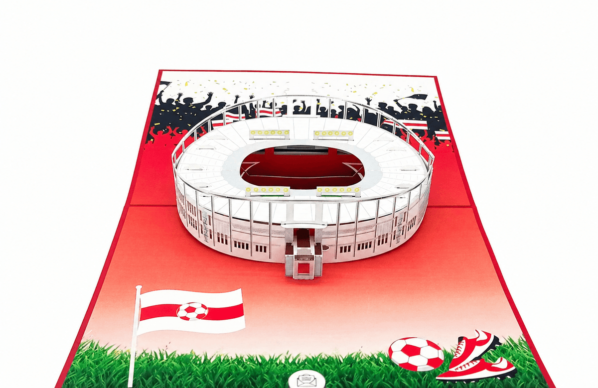 Aufgeklappte Pop-up-Karte mit dem Stuttgarter Stadion, Fahne, Fußball und Fußballschuhen auf grünem Rasen.