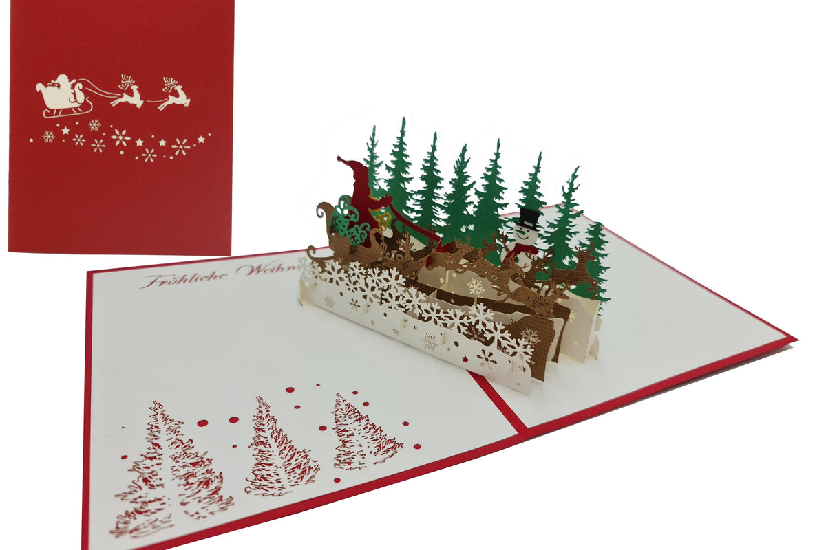 Aufgeklappte Pop-up-Karte mit Weihnachtsmann im Rentierschlitten über einer Schneeflocken-Bordüre und grünen Tannen, im Hintergrund die rote Kartenvorderseite mit Schlittenmotiv.