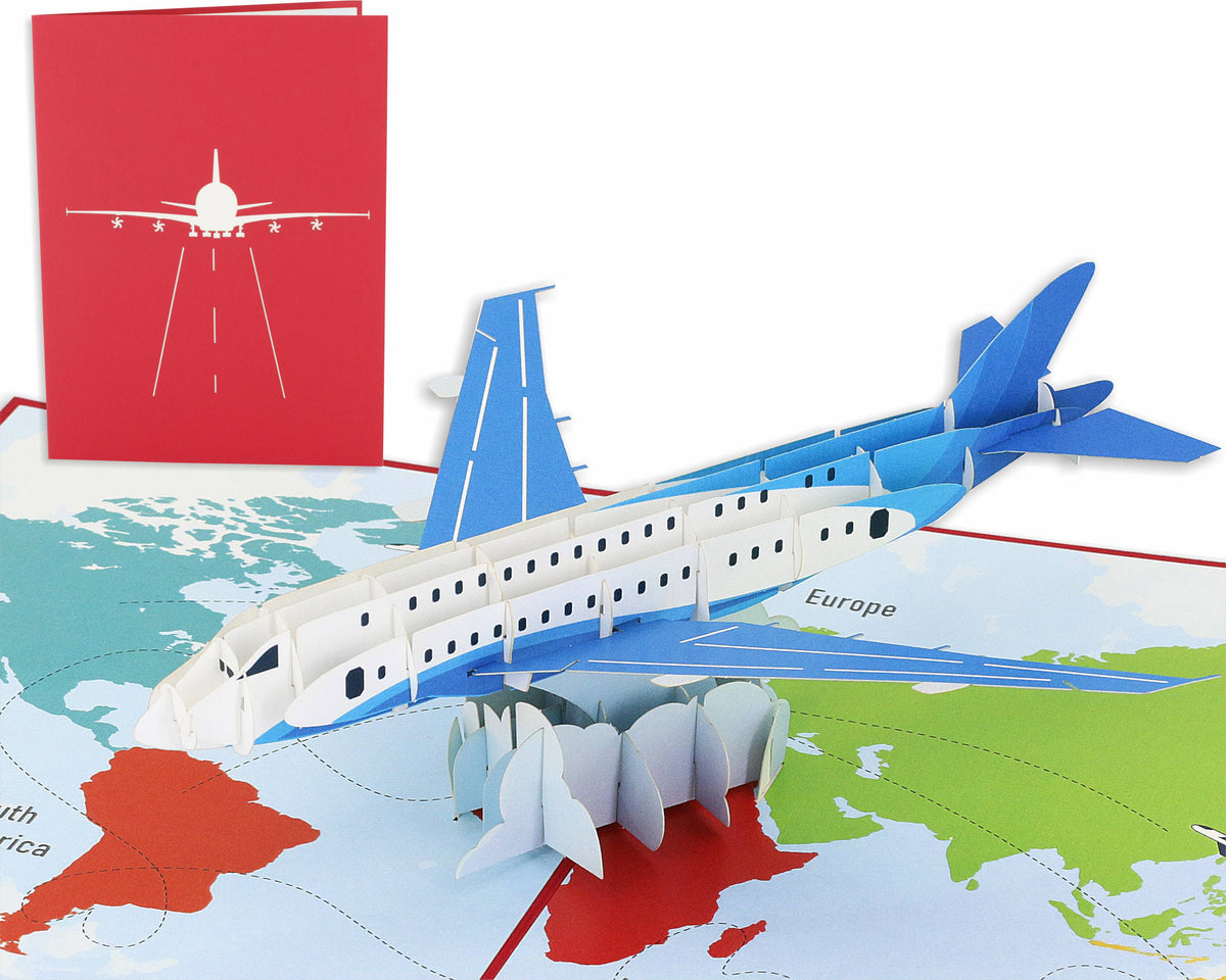 Aufgeklappte Pop-up-Karte mit einem blau-weißen Passagierflugzeug über einer bunten Weltkarte, dahinter die rote Kartenvorderseite mit Flugzeug-Scherenschnitt.