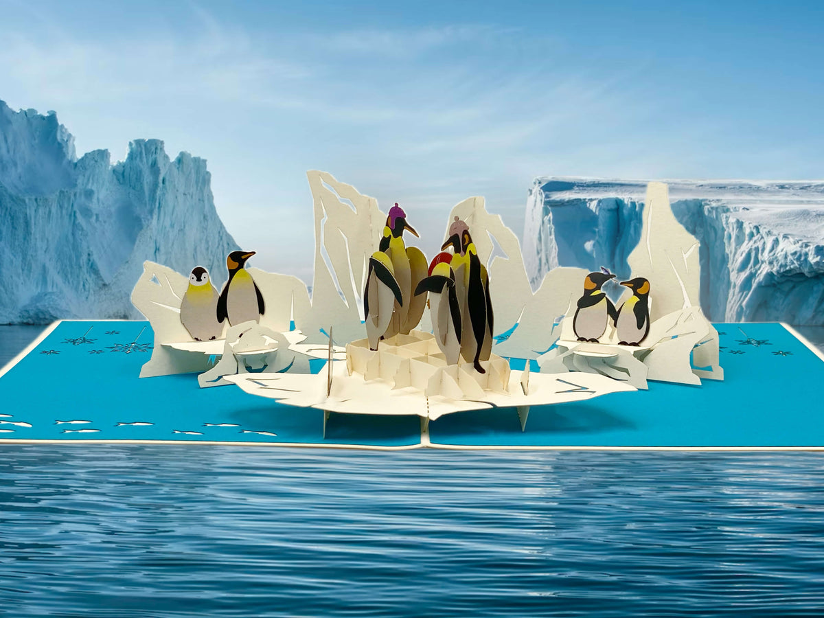 pop-up-karte-mit-pinguinen-auf-eisschollen-im-meer
