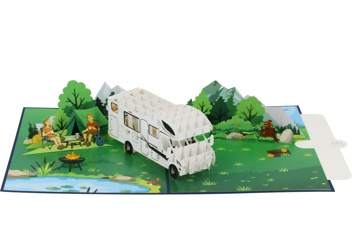 Aufgeklappte Pop-up-Karte mit Wohnmobil und Campingszene, von schräg oben fotografiert.