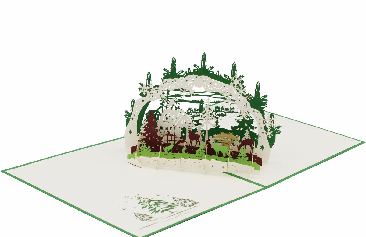 Klappkarte schwibbogen mit einer winterlandschaft, futterkrippe und tieren