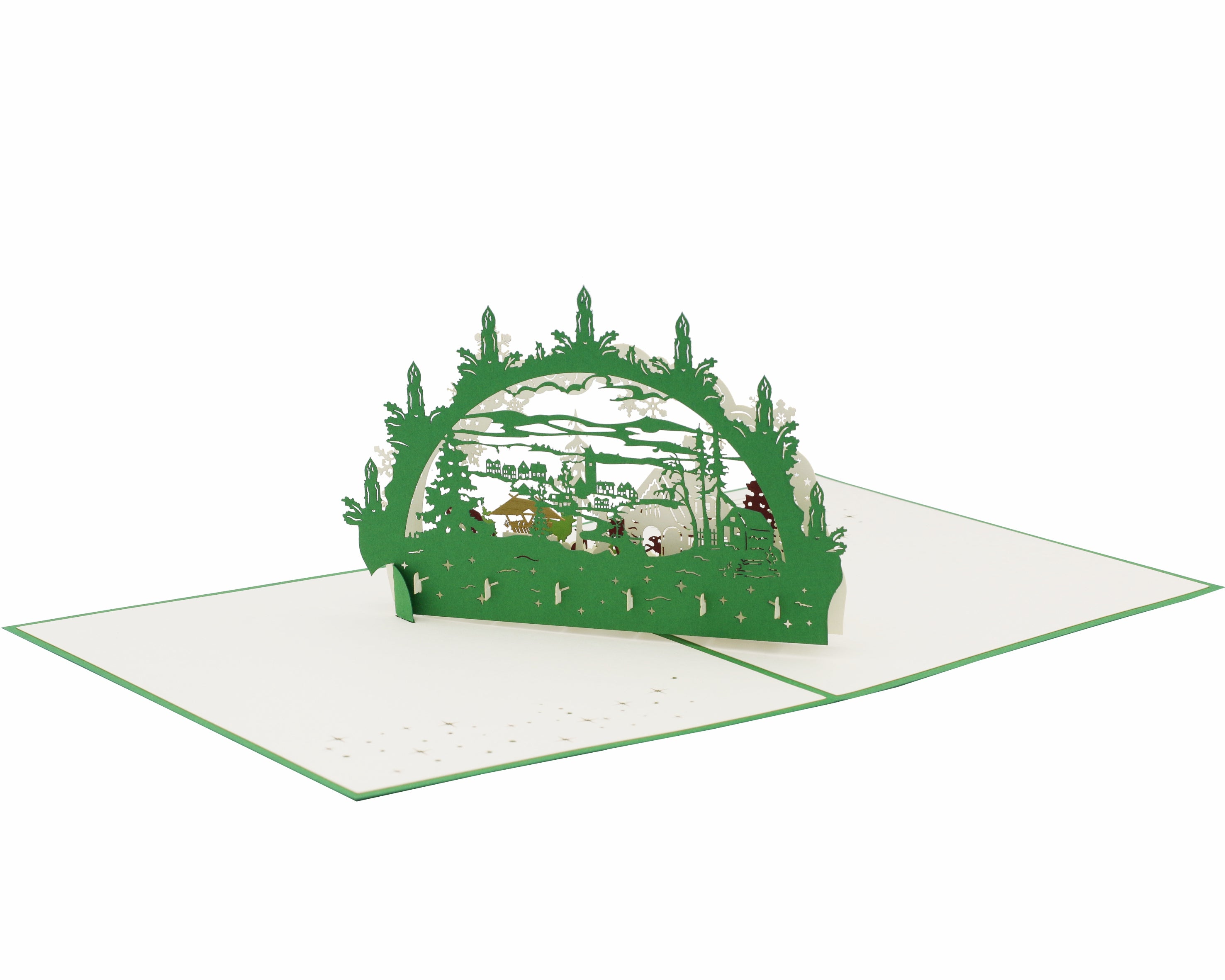 Aufgeklappte Pop-up-Karte mit grünem Schwibbogen und Winterlandschaft, von schräg oben fotografiert.