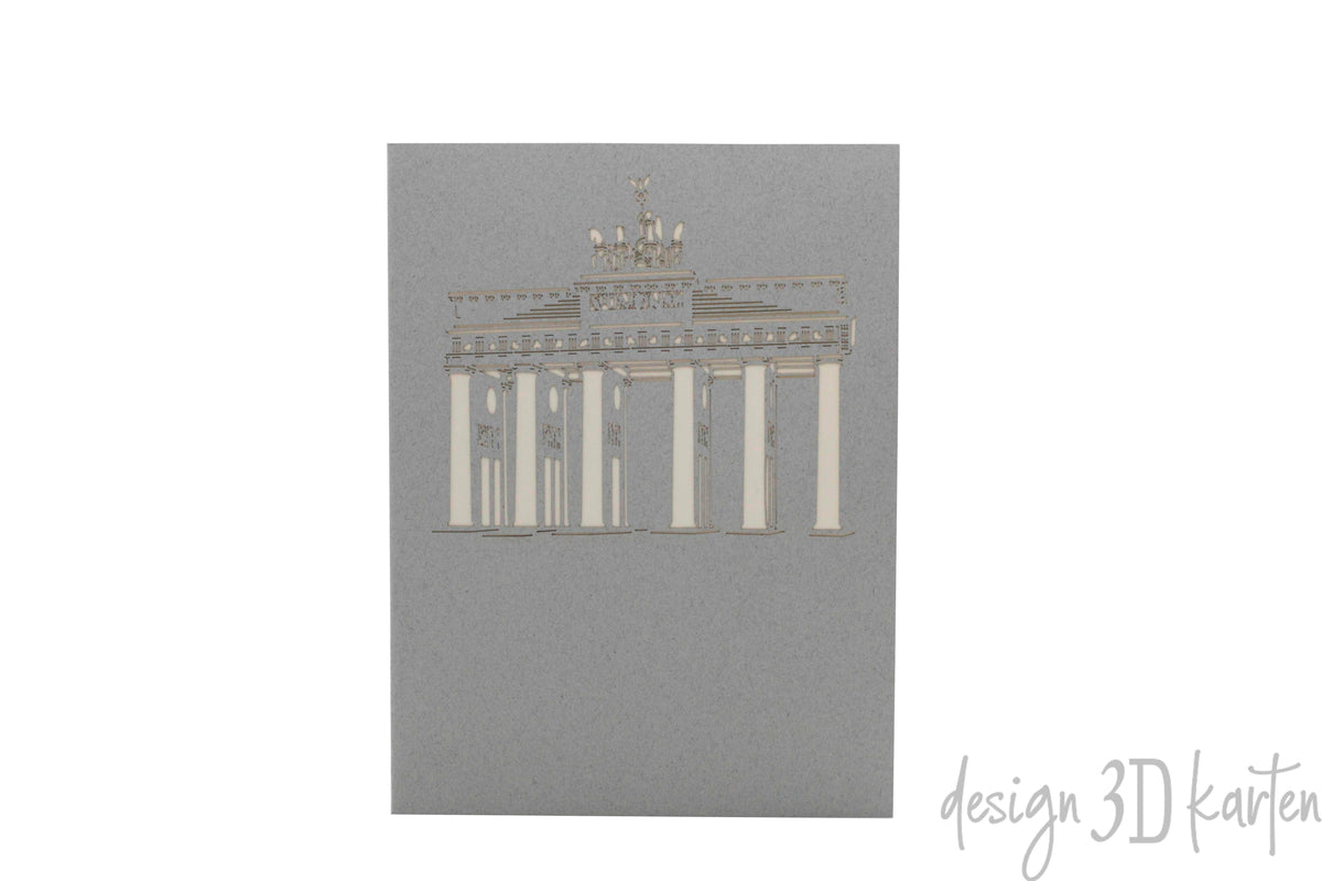Graue Kartenvorderseite mit dem Brandenburger Tor als Scherenschnitt.
