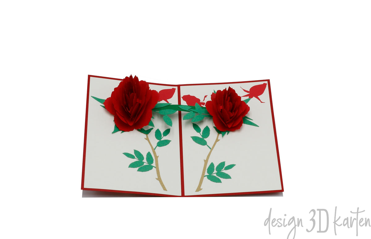 Aufgeklappte Pop-up-Karte mit rotem Rand und zwei roten Rosen mit grünen Blättern.