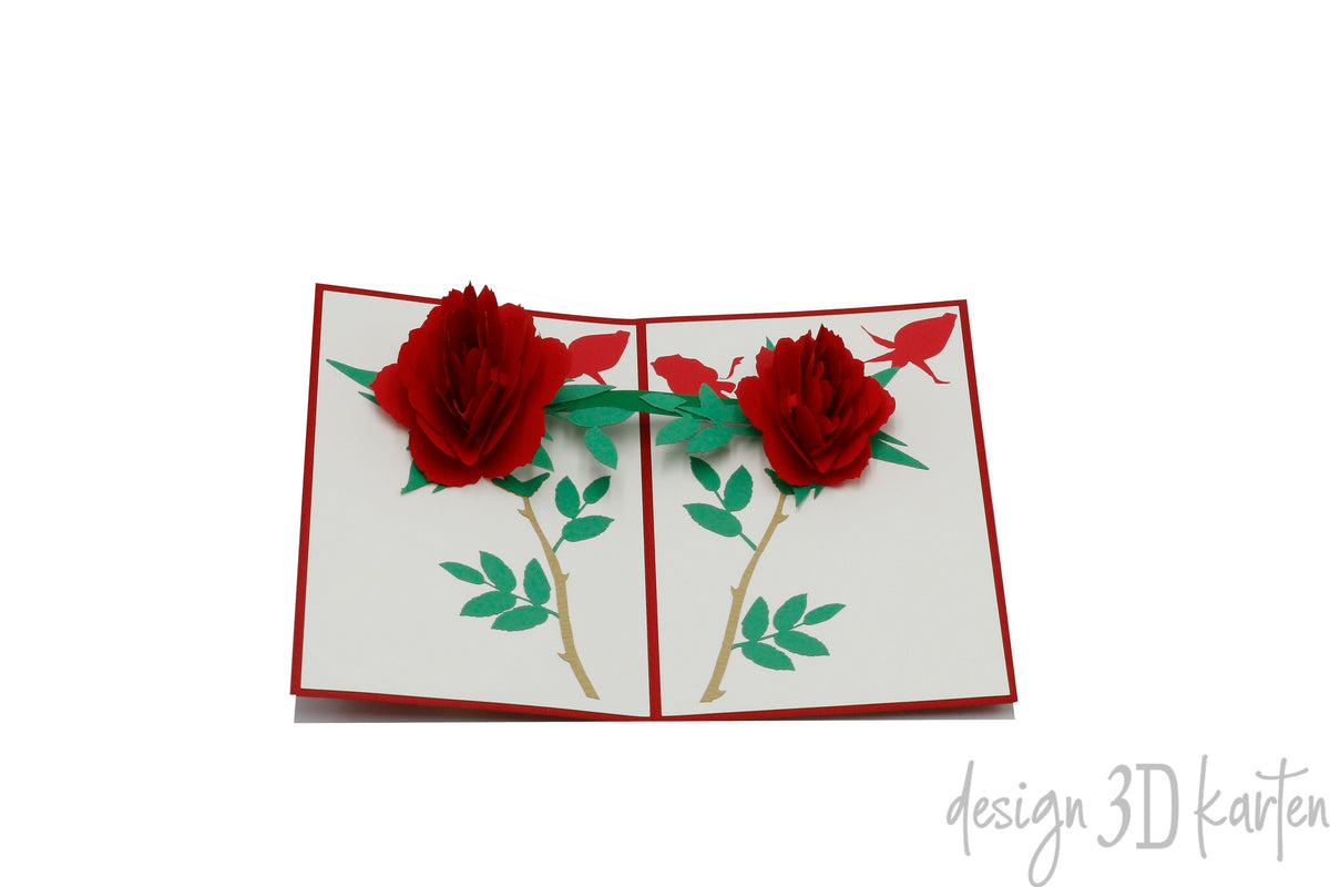 Aufgeklappte Pop-up-Karte mit rotem Rand und zwei roten Rosen mit grünen Blättern.
