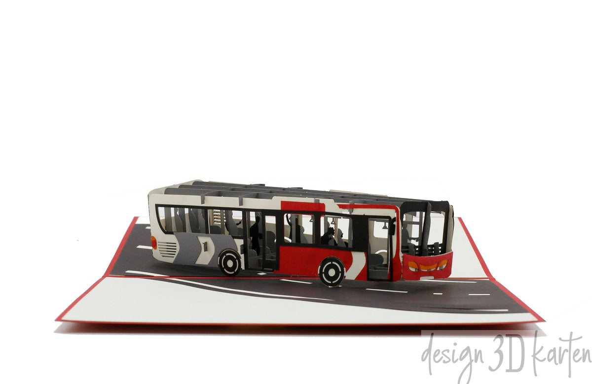 Aufgeklappte Pop-up-Karte mit rotem Rand und einem rot-weißen Gelenkbus auf einer Straße.