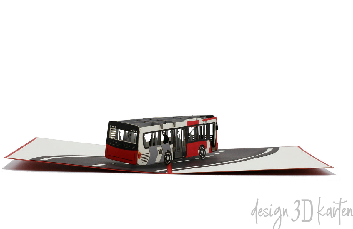 Aufgeklappte Pop-up-Karte mit einem Bus, flach von vorne fotografiert.