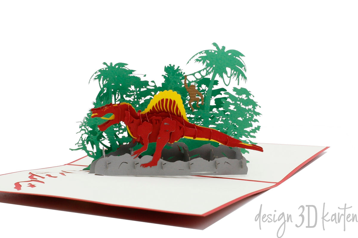 Nahaufnahme der aufgeklappten Pop-up-Karte mit rotem Dinosaurier zwischen Palmen und Farnen.