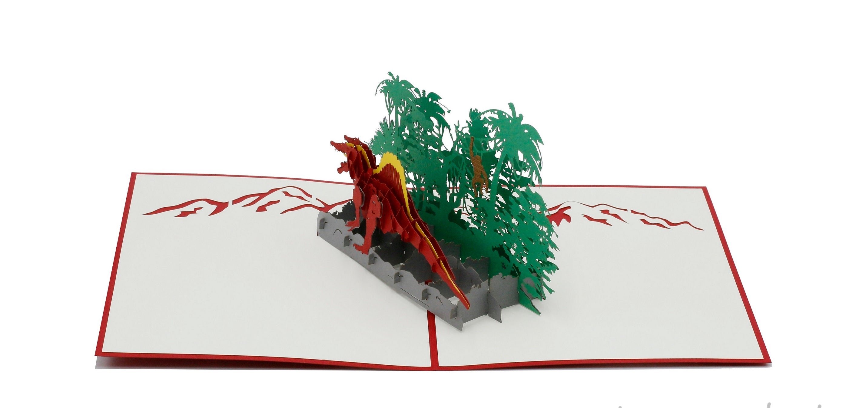Aufgeklappte Pop-up-Karte mit Dinosaurier und Dschungel, frontal fotografiert.