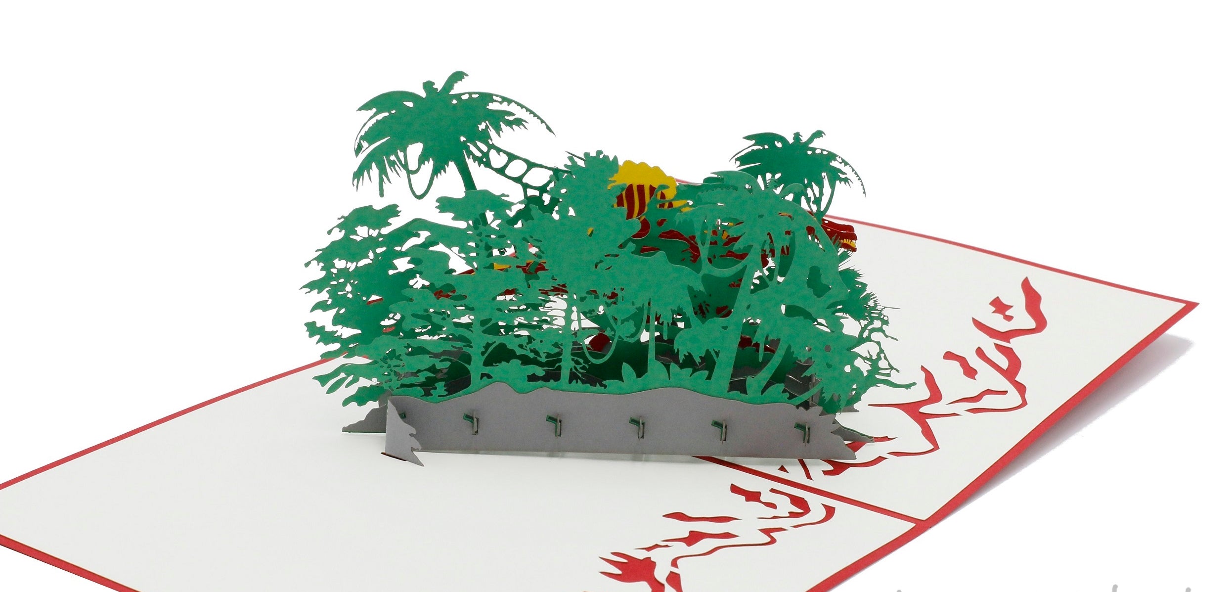 Aufgeklappte Pop-up-Karte mit Dinosaurier aus Papier, von schräg oben fotografiert.