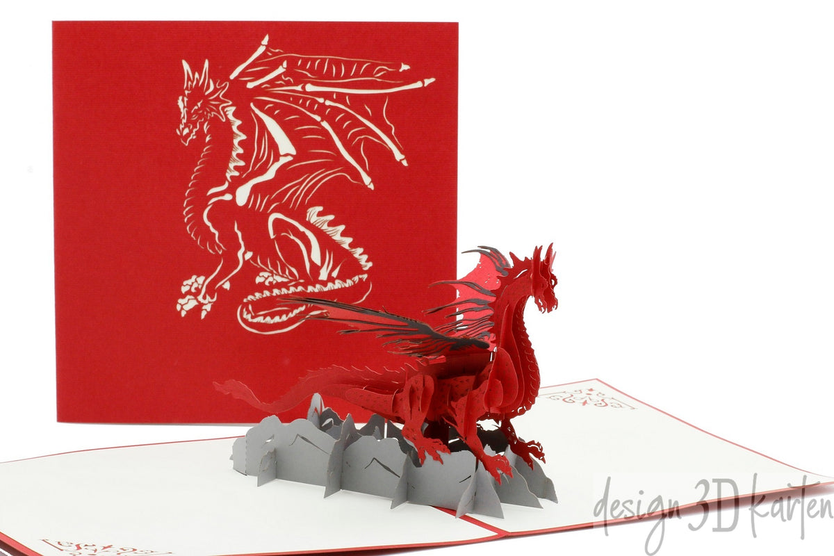 Aufgeklappte Pop-up-Karte mit rotem Drachen, dahinter die rote Kartenvorderseite mit Drachen-Scherenschnitt.