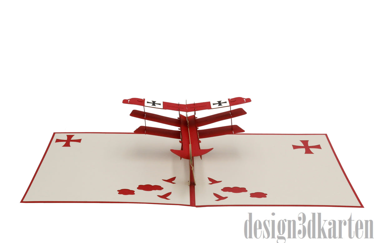 Aufgeklappte Pop-up-Karte mit rotem Flugzeug aus Papier, frontal von vorne fotografiert.