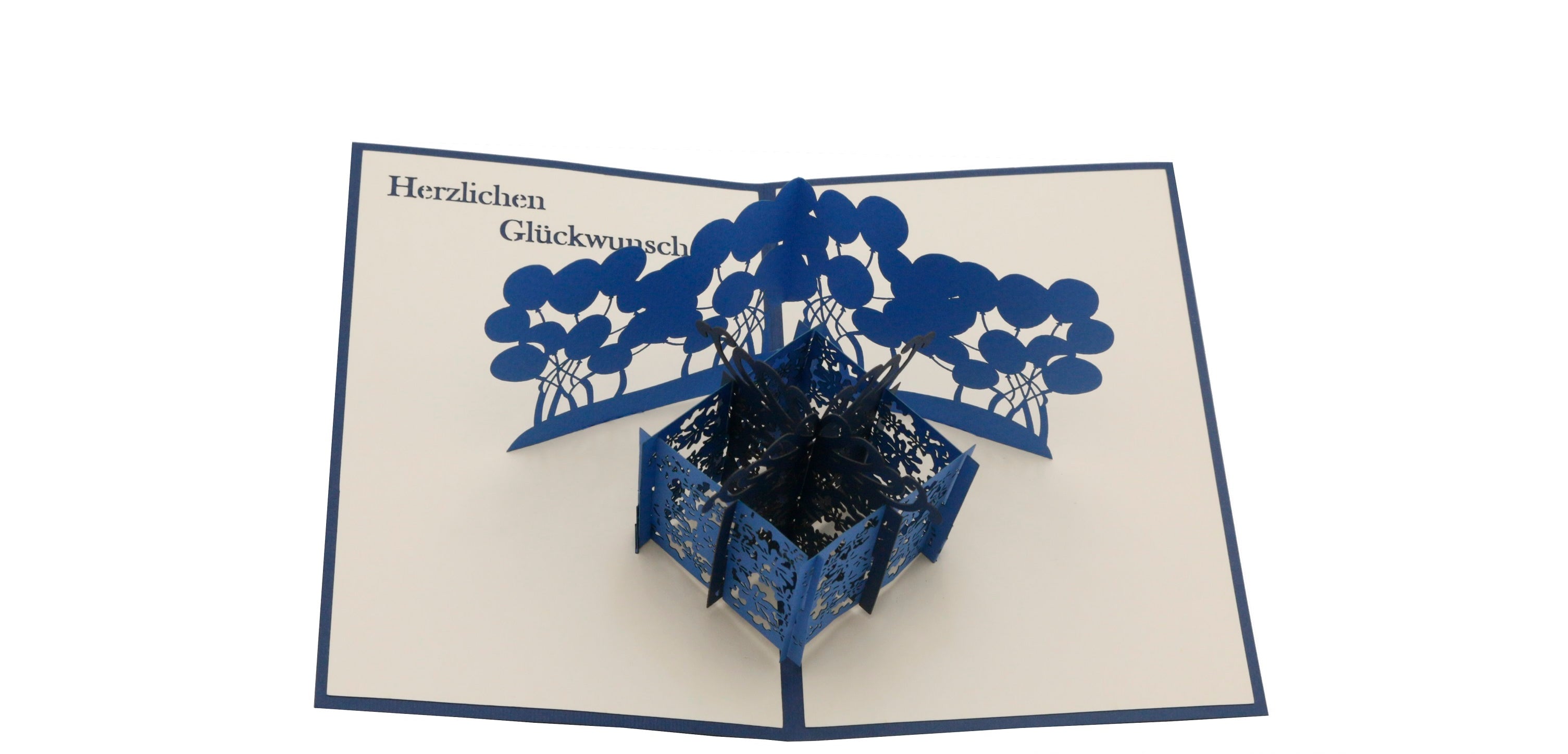 Aufgeklappte Pop-up-Karte mit dunkelblauem Rand: eine blaue Geschenkbox mit blauen Luftballons.
