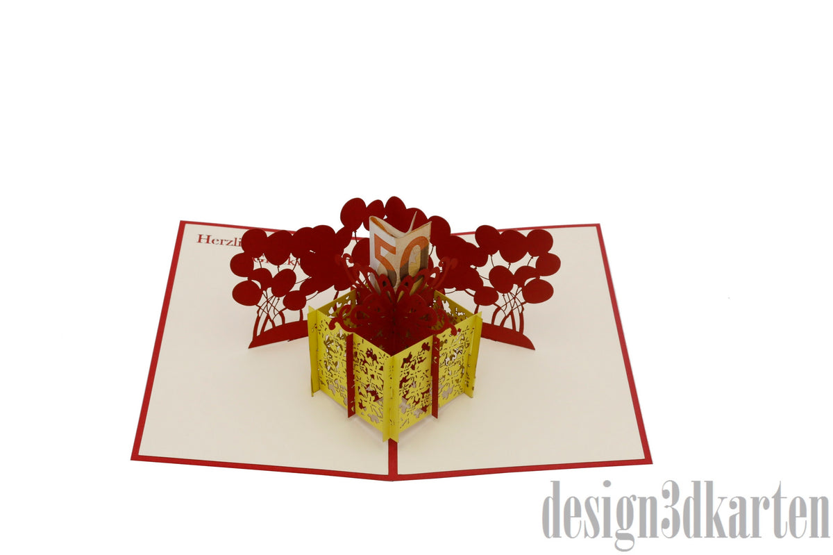 Aufgeklappte Pop-up-Karte mit rotem Rand: eine gelbe Geschenkbox, aus der rote Luftballons und ein Geldschein aufsteigen.