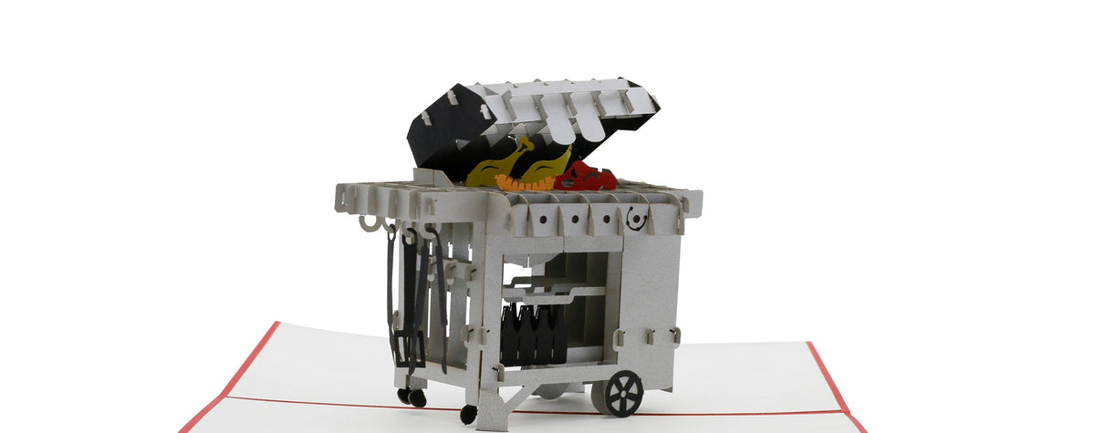 Aufgeklappte Pop-up-Karte mit rotem Rand und einem detailreichen Gasgrill mit geöffnetem Deckel.