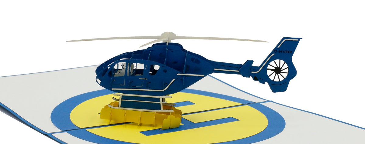 Nahaufnahme der aufgeklappten Pop-up-Karte mit einem blauen Hubschrauber aus Papier.
