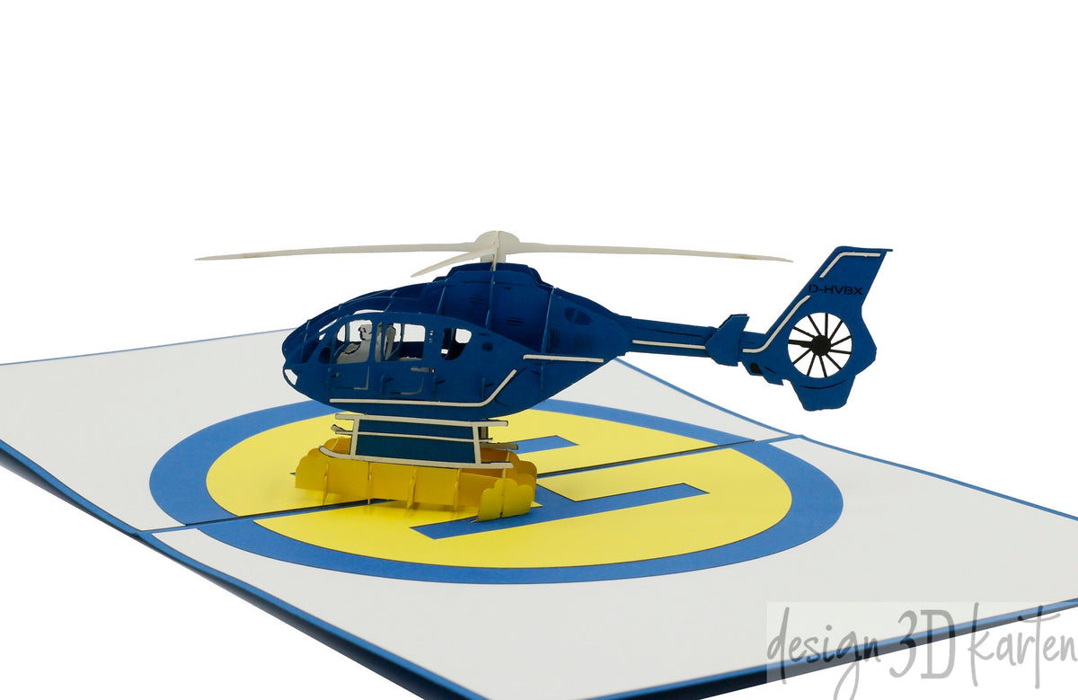 Nahaufnahme der aufgeklappten Pop-up-Karte mit einem blauen Hubschrauber aus Papier.