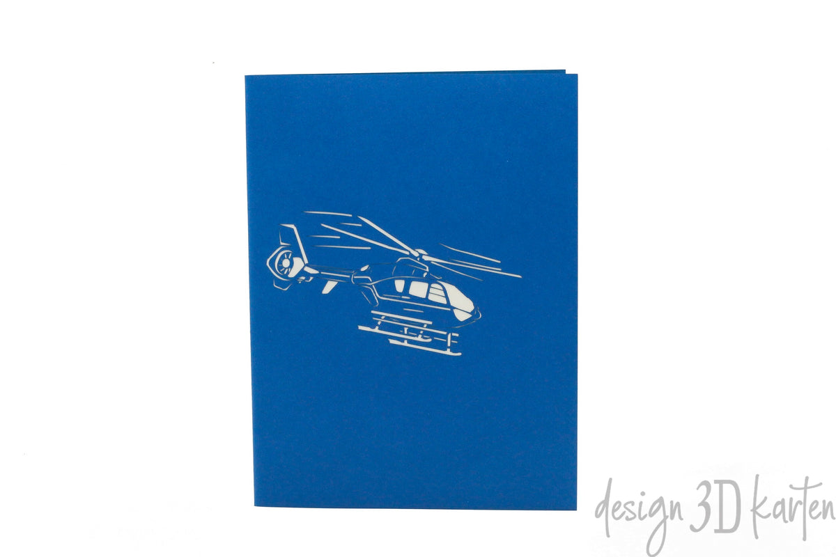 Blaue Kartenvorderseite mit einem Hubschrauber als Scherenschnitt.