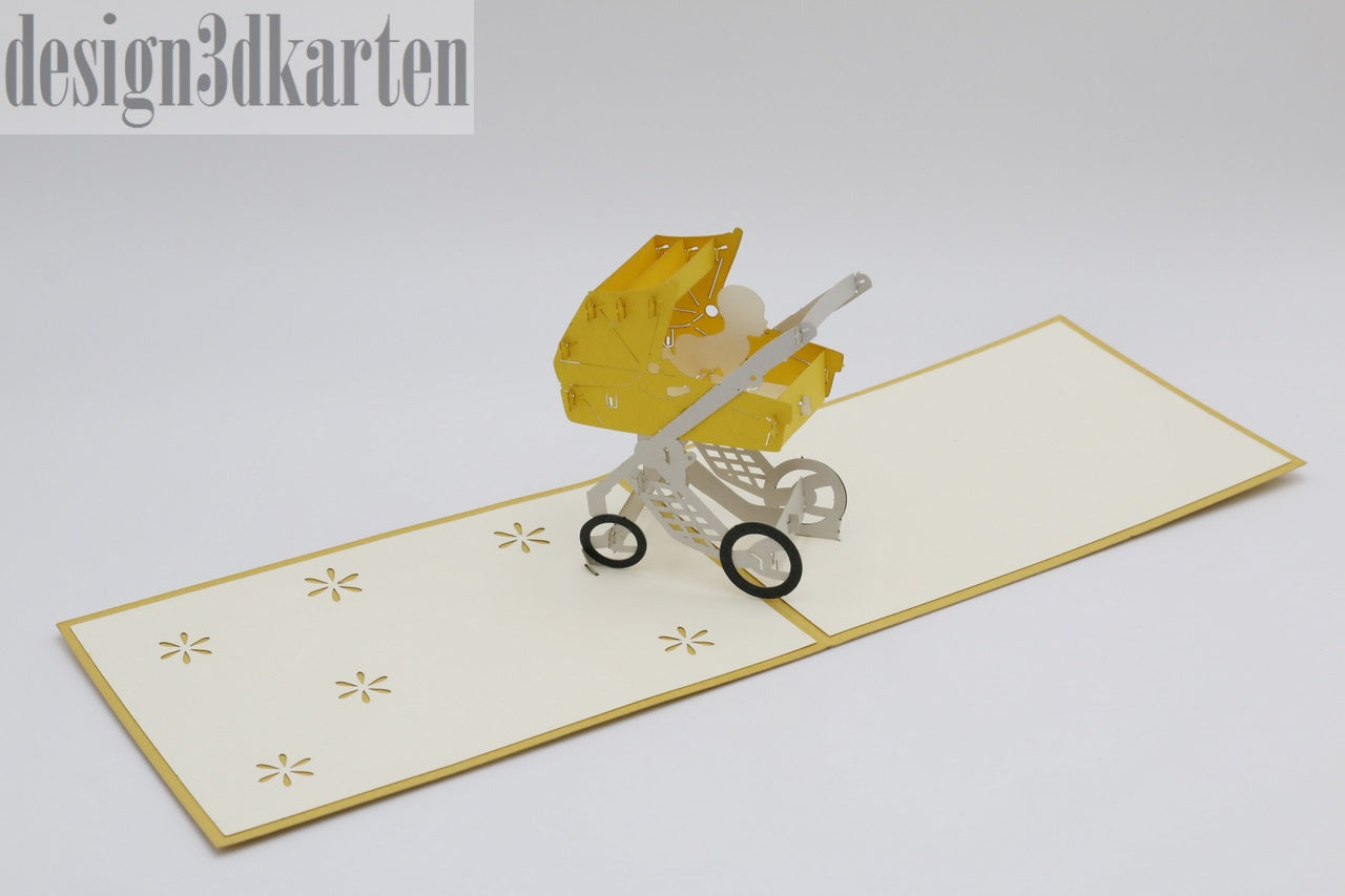 Aufgeklappte Pop-up-Karte mit gelbem Kinderwagen, schräg von oben fotografiert.