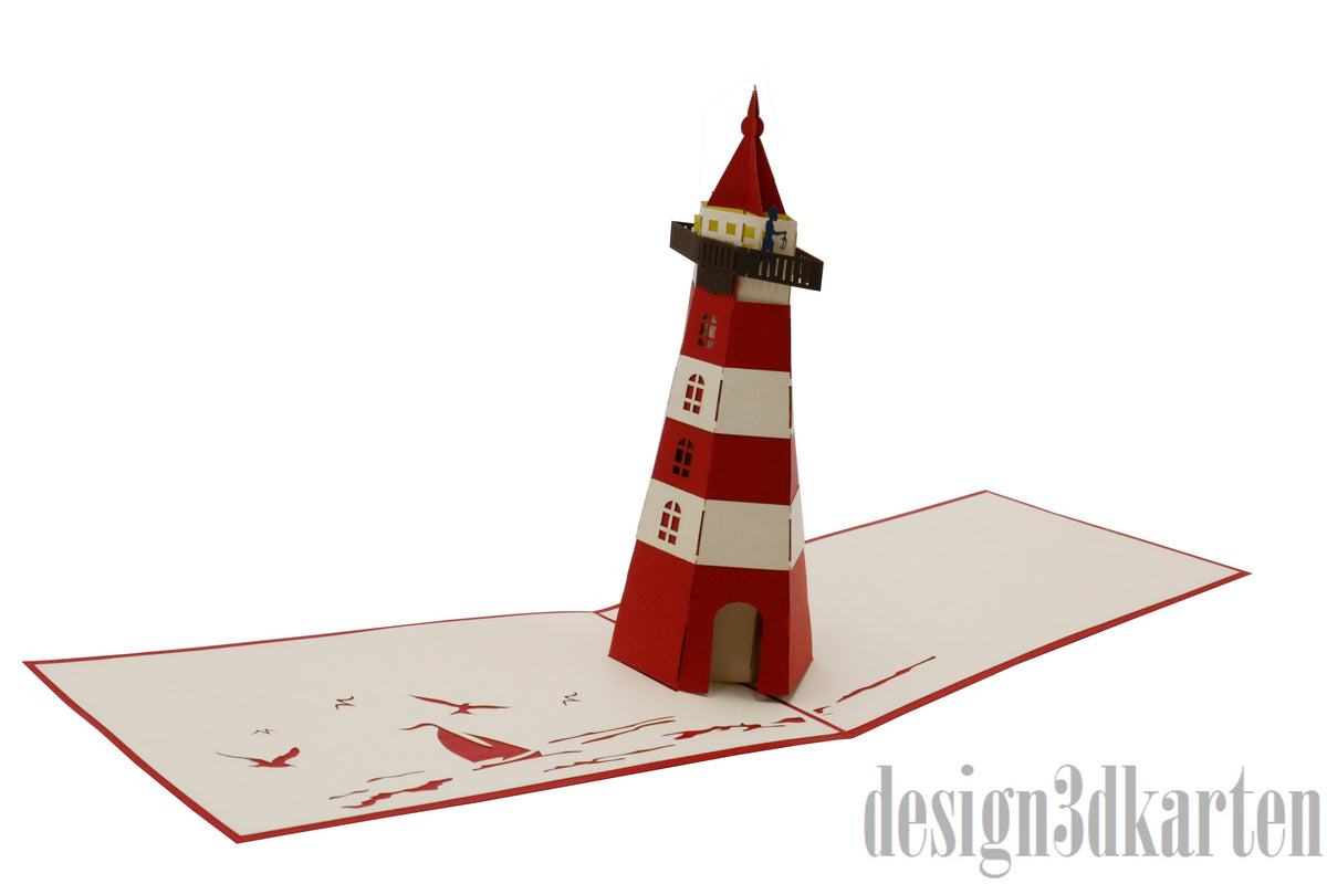 Aufgeklappte Pop-up-Karte mit einem rot-weiß gestreiften Leuchtturm aus Papier.