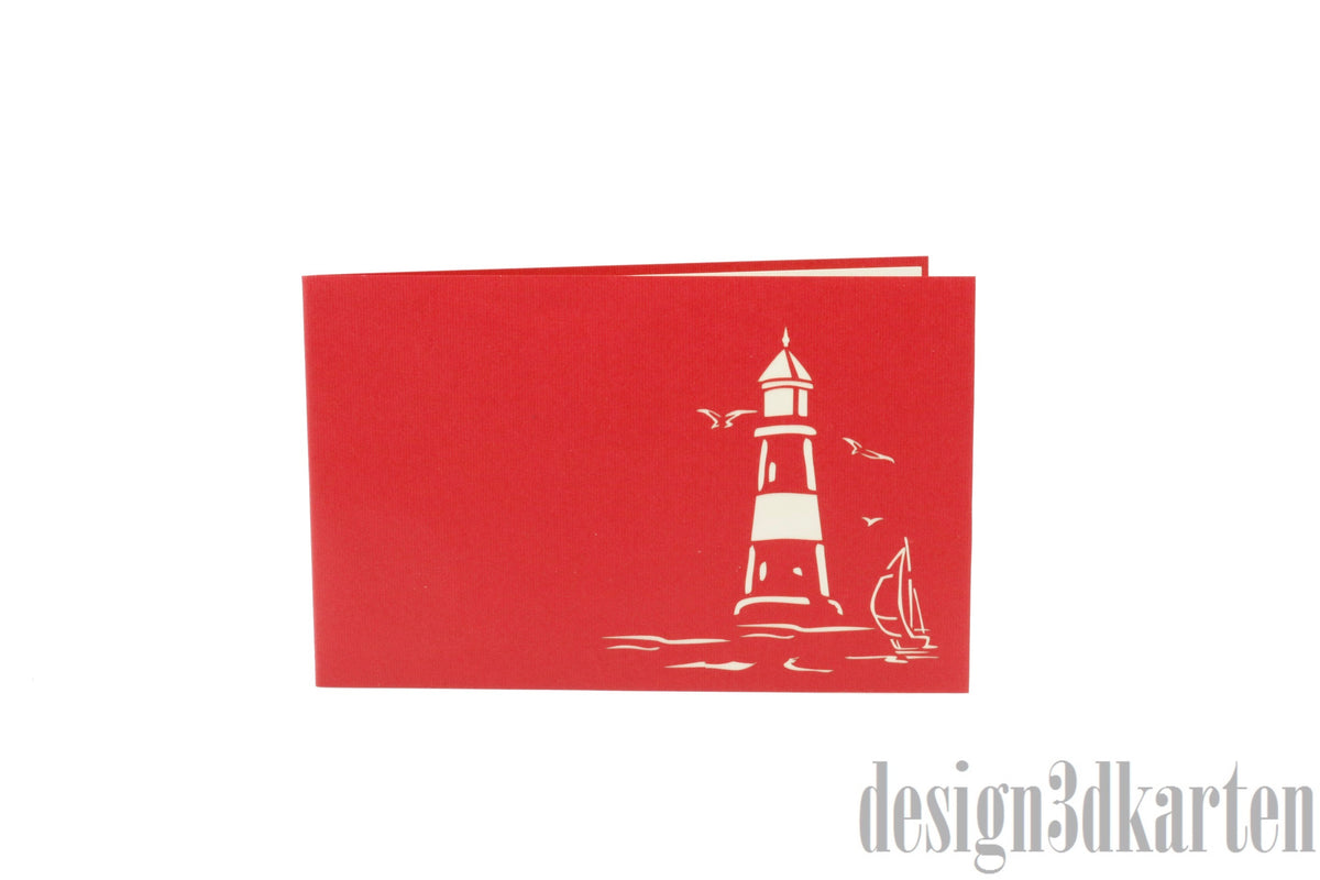 Rote Kartenvorderseite mit einem Leuchtturm, Möwen und Segelboot als Scherenschnitt.