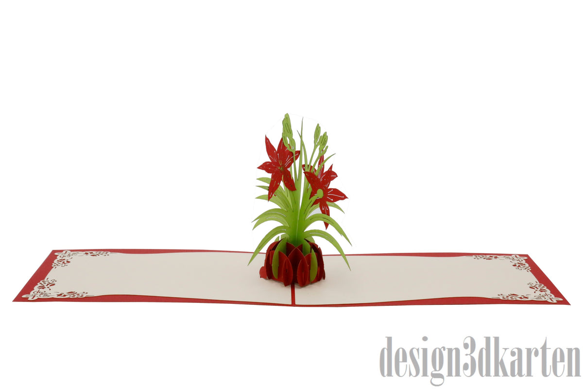 Aufgeklappte Pop-up-Karte mit roten Lilien in einer Vase, flach von vorne fotografiert.
