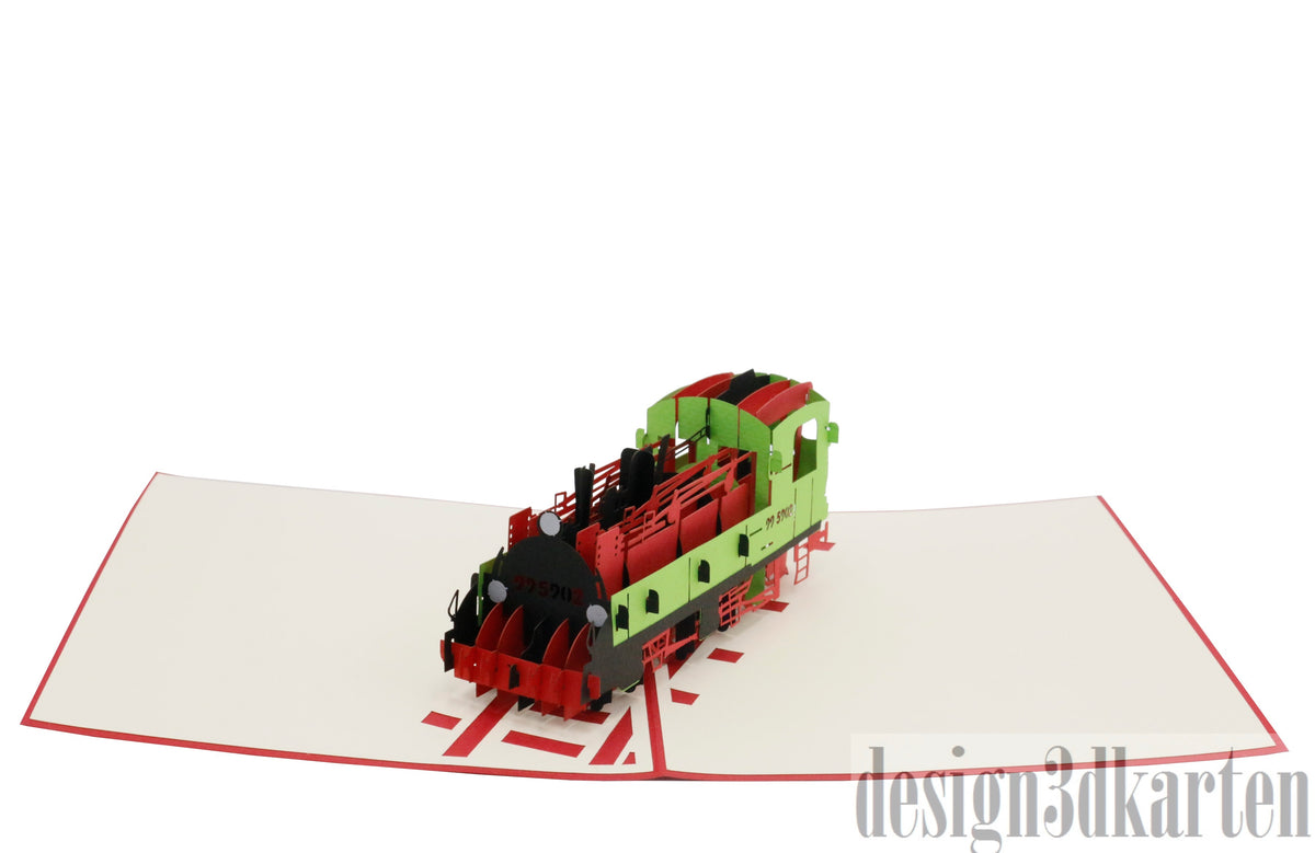 Aufgeklappte Pop-up-Karte mit einer Lokomotive aus Papier, von oben fotografiert.