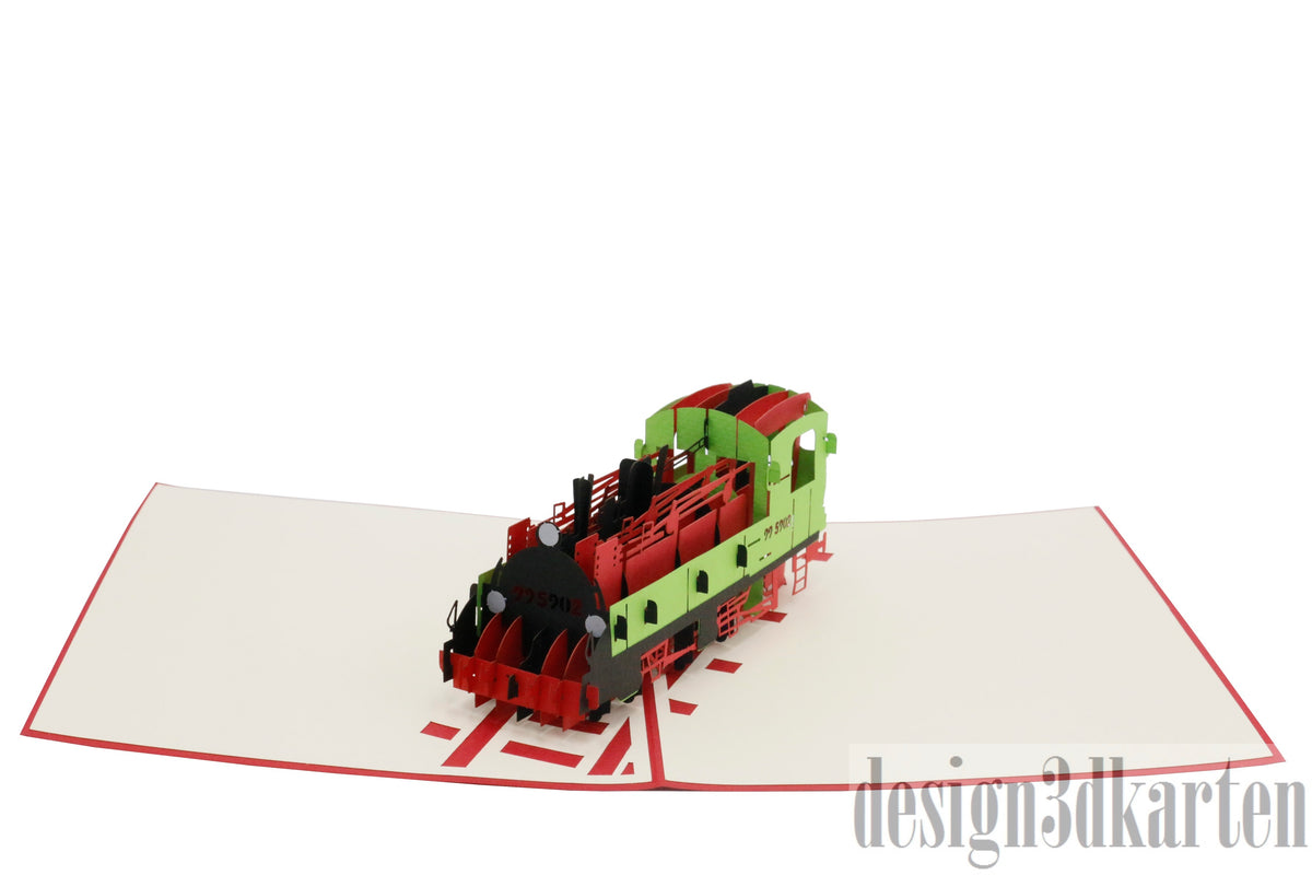 Aufgeklappte Pop-up-Karte mit einer Lokomotive aus Papier, von oben fotografiert.