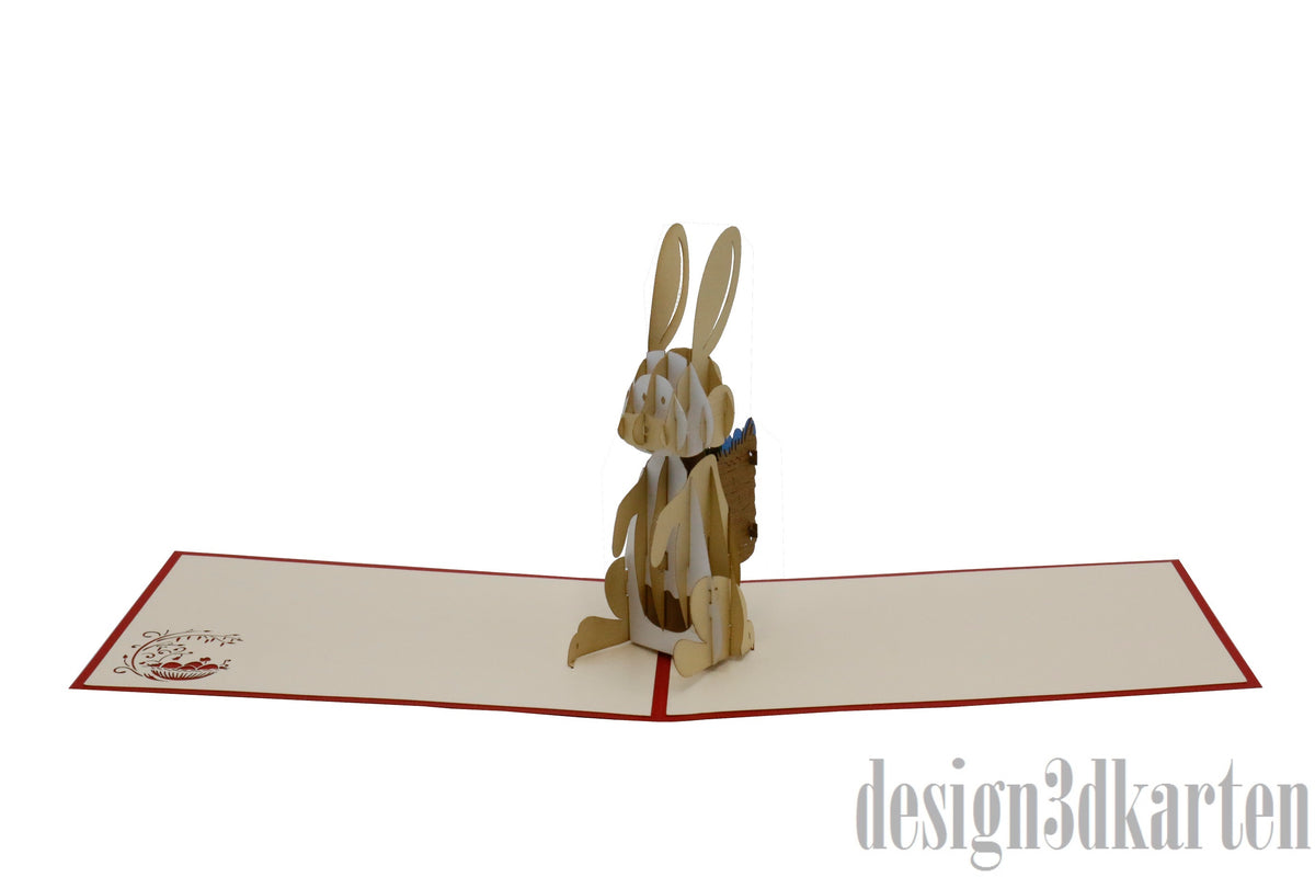 Aufgeklappte Pop-up-Karte mit Osterhase, flach von vorne fotografiert.