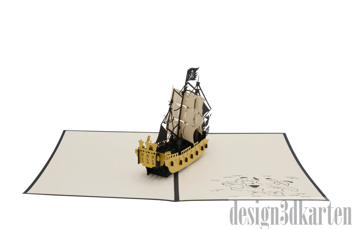 Aufgeklappte Pop-up-Karte mit Piratenschiff, schräg von oben fotografiert.
