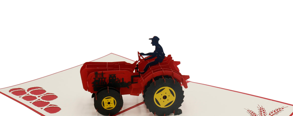 Nahaufnahme der aufgeklappten Pop-up-Karte mit rotem Oldtimer-Traktor und Fahrerfigur.