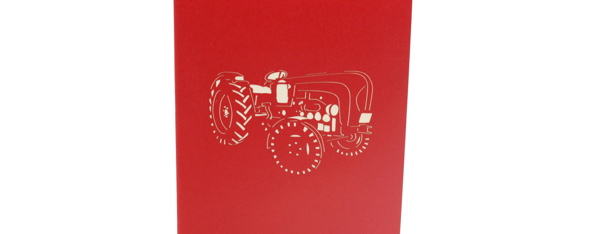 Rote Kartenvorderseite mit einem Oldtimer-Traktor als Scherenschnitt.