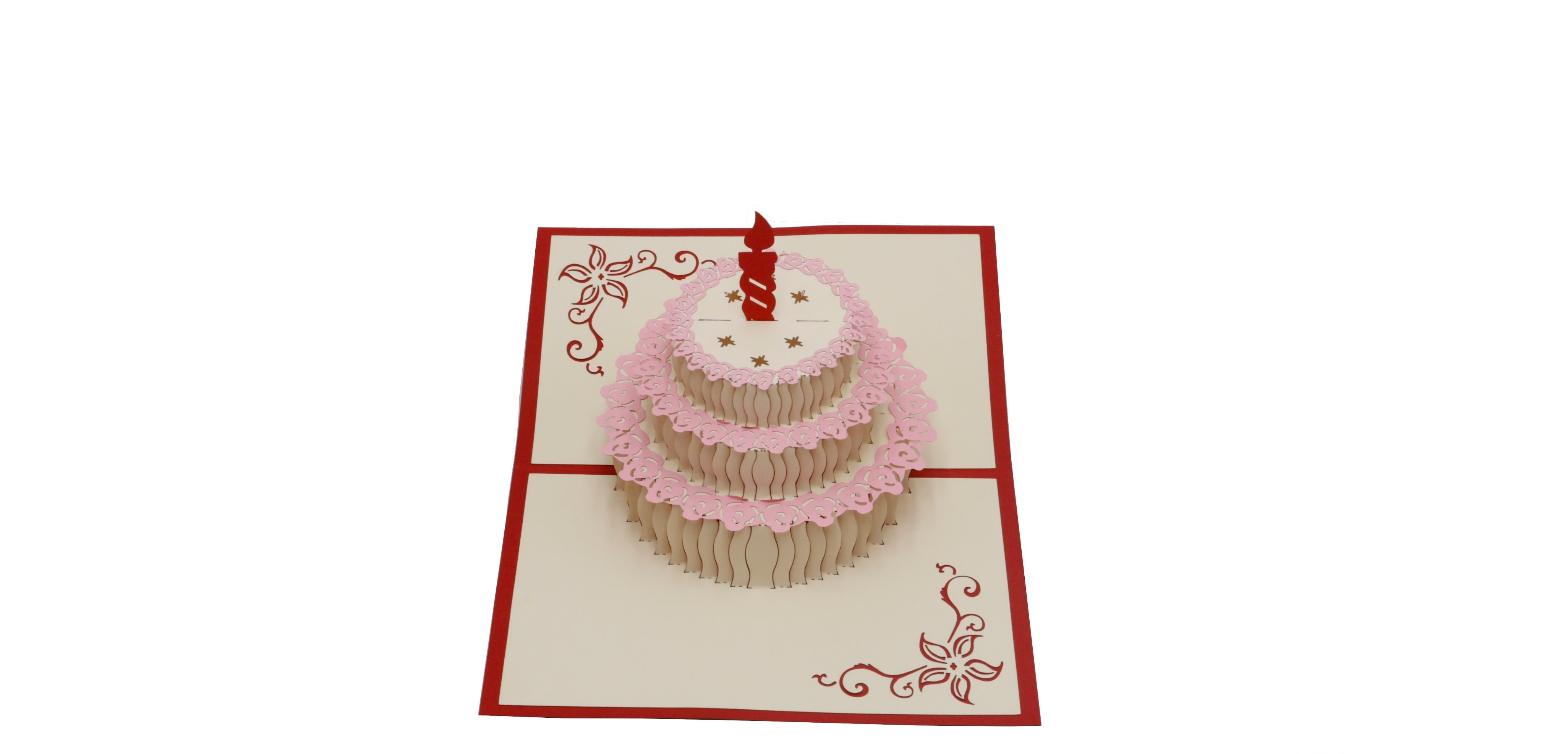 Aufgeklappte Pop-up-Karte mit einer Torte mit roter Kerze und rosa Spitzendekor.